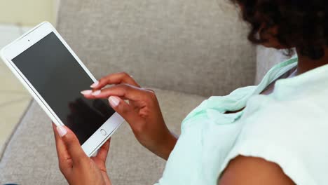 Woman-using-digital-tablet-in-living-room-4k