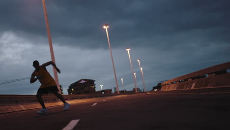 hombre bailando joven bailarín de break realizando movimientos de baile moderno de hip hop practicando coreografía de estilo libre urbano en la calle de la ciudad por la noche