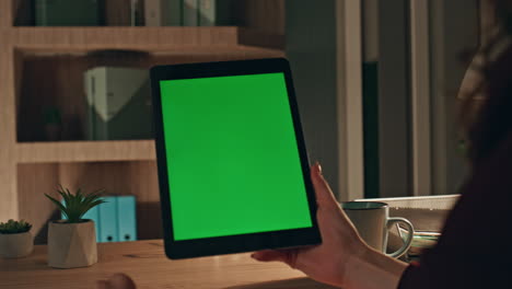 web designer working greenscreen tablet on remote workplace at evening close up