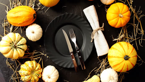 Black-plate-surrounded-by-yellow-pumpkins