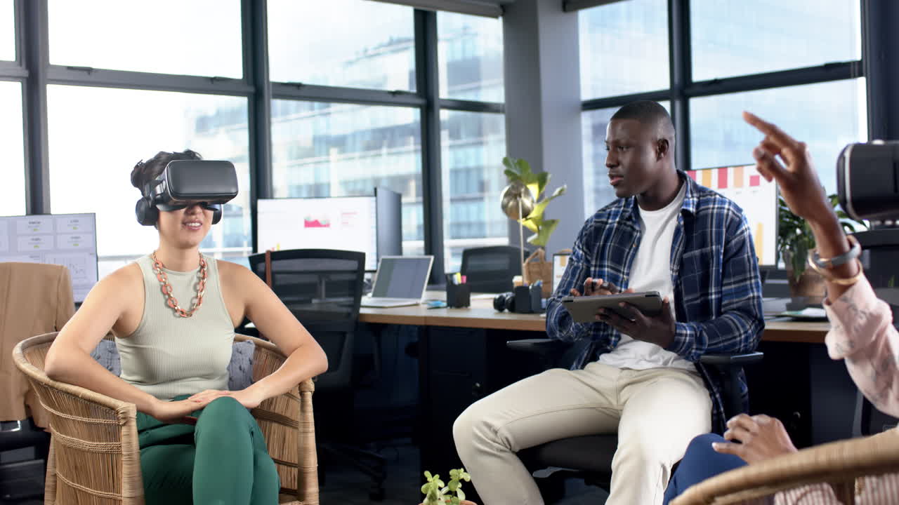 Casual diverse business people using vr headsets working together in office, slow motion, copy space