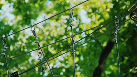 a brave child walks along a tightrope between tall trees active childhood and fun