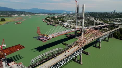 pattullo bridge replacement, cable-stayed bridge under construction spanning the fraser river in bc, canada. - aerial shot