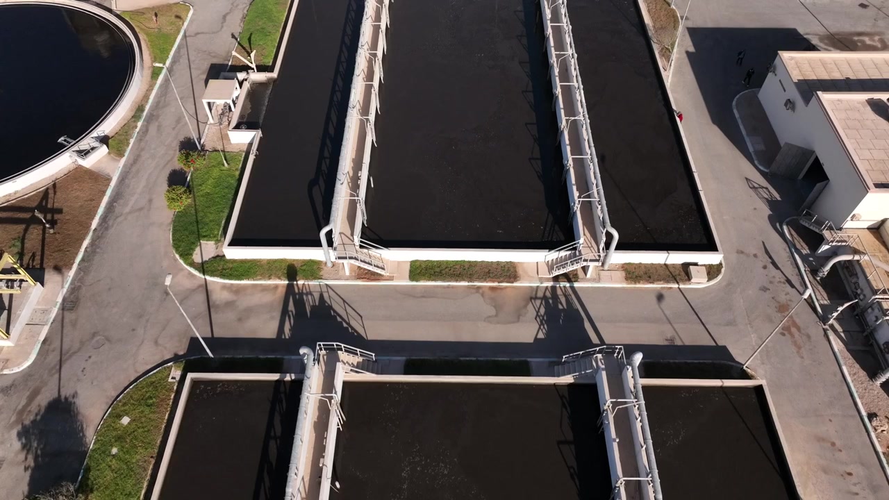 Top down aerial drone view of industrial water treatment basins and engineering infrastructure in Dakhla Morocco ideal for environmental projects