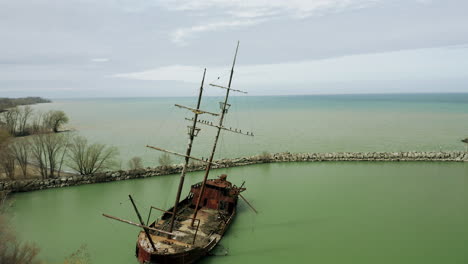 Rusty-red-shipwreck-stuck-in-shallow-green-water