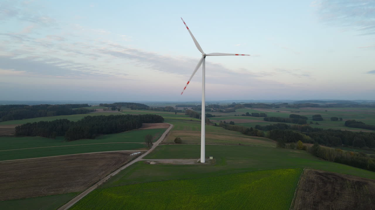 Scenic Meadow Landscape With Slowly Rotating Propeller Of Wind Turbines In Lubawa, Poland