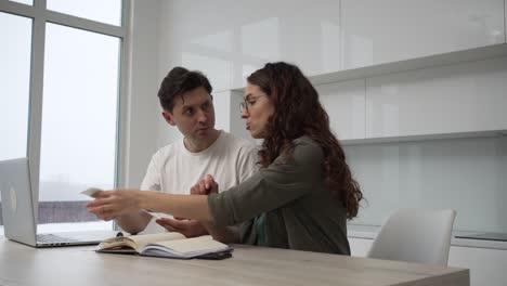 couple argues about family costs after calculation gesturing