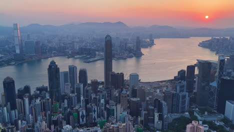 cinematic aerial view of hong kong skyline at golden hour featuring ifc and icc towers, symbolizing global finance, modern architecture, and a vibrant hub for travel and business