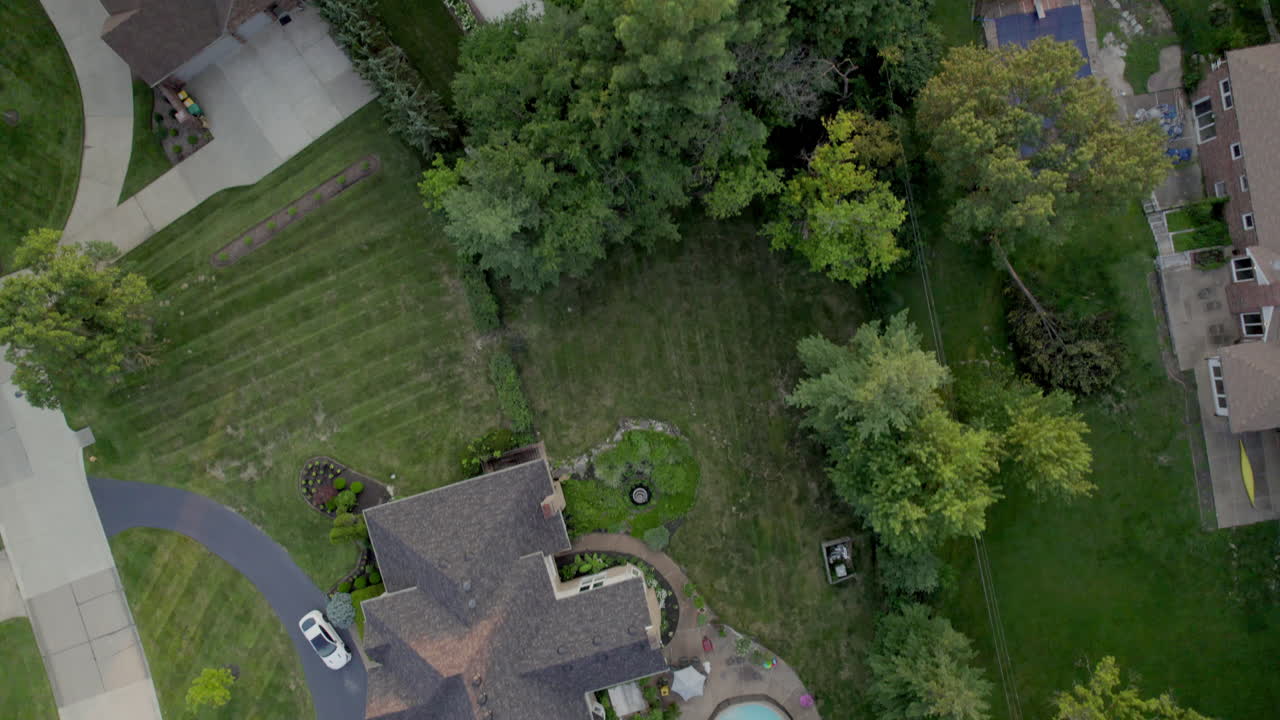 Top down aerial scroll over beautiful houses in nice upscale neighborhood in Town and Country in St