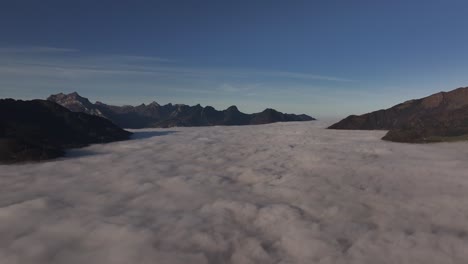 vista aérea de walensee, suiza, que muestra un mar de niebla que cubre el valle con picos de montañas emergiendo y la luz del sol añadiendo al tranquilo paisaje alpino.