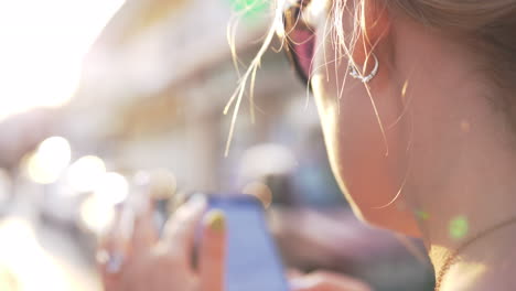 Woman-surfing-internet-on-mobile-in-city-street