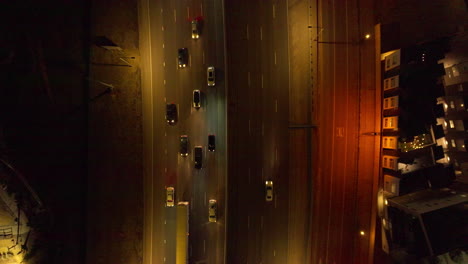 aerial view of top down shot of cars driving down interstate at night in denver, colorado