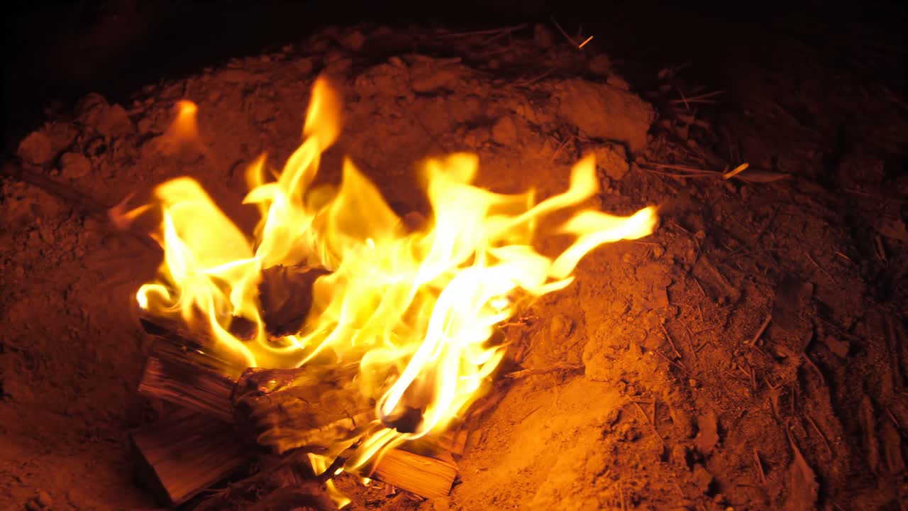 hombre cocinando comida en el fuego del campamento en el bosque 4k