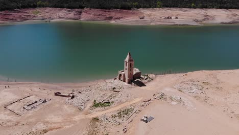 empty reservoir with a ruined church