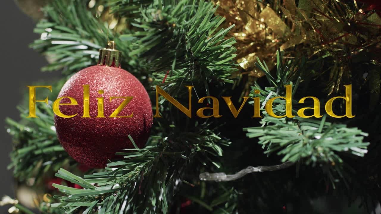 feliz navidad texto en oro sobre decoraciones en el árbol de navidad