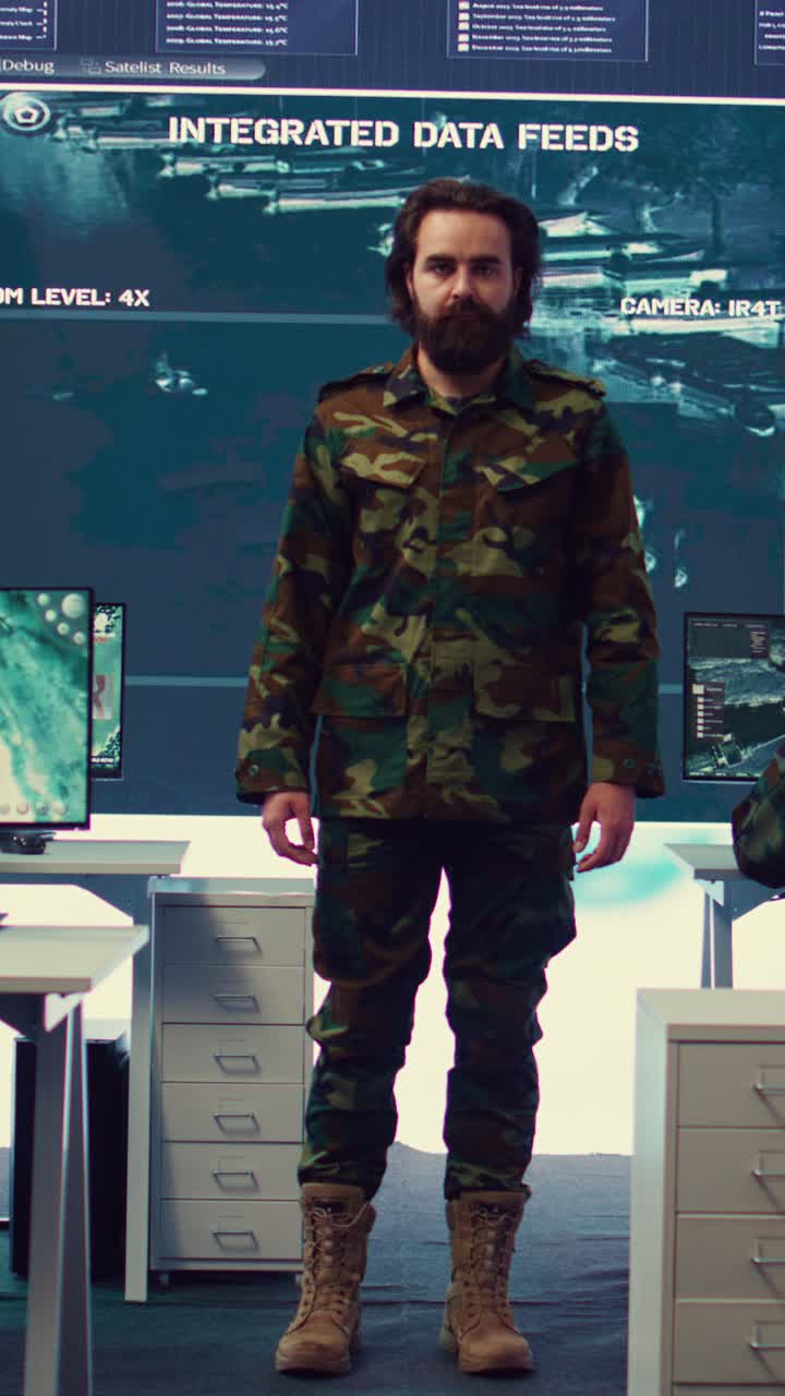 Uomo barbuto in uniforme militare che saluta nella sala di controllo