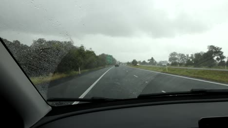 driving on a wet highway, view from inside the car