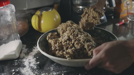 Mano-De-Panadero-Mezclando-Masa-De-Galleta-Con-Una-Cuchara-De-Madera---Primer-Plano,-Tiro-Estático