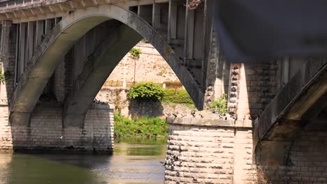 stone arch bridge over calm canal waters