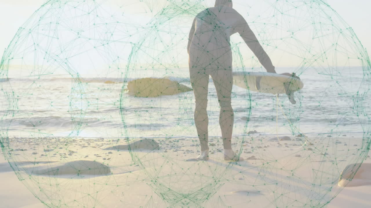 Man wearing wetsuit examining surfboard on beach, with teal network overlay showing tech trends
