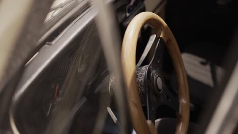 close up of a vintage volkswagen beetle's interior, focusing on the wooden steering wheel