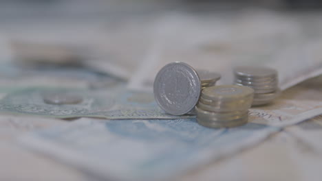 Close-Up-Of-Stacked-Coins-On-Polish-Banknotes