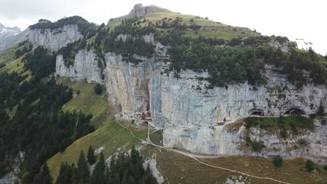wonderful aerial view of the ebenalp mountain with the wildkirchli caves and the aescher cliff restaurant nestled into the rock face alpstein, switzerland