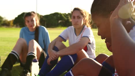 female soccer team in break time talking on soccer field. 4k