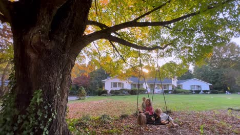children playing on a swing in autumn