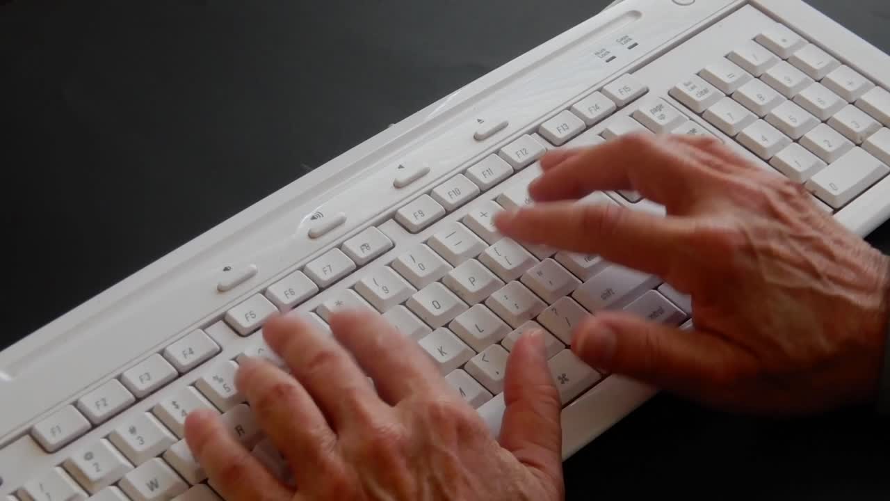 Busy hands typing and working on a computer keyboard 