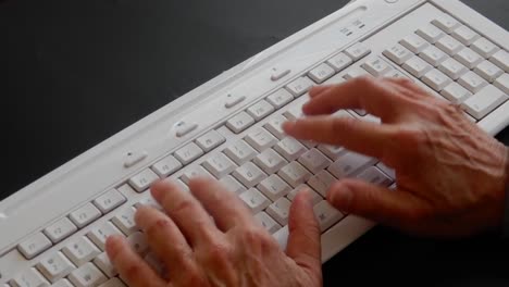 busy hands typing and working on a computer keyboard