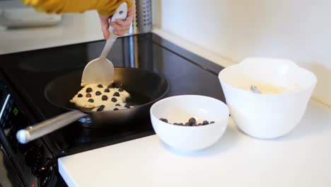 Mid-section-of-man-mixing-dough-in-bowl