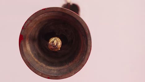 isolated-holy-copper-bell-hanging-with-ceiling-at-temple-low-angle-shot