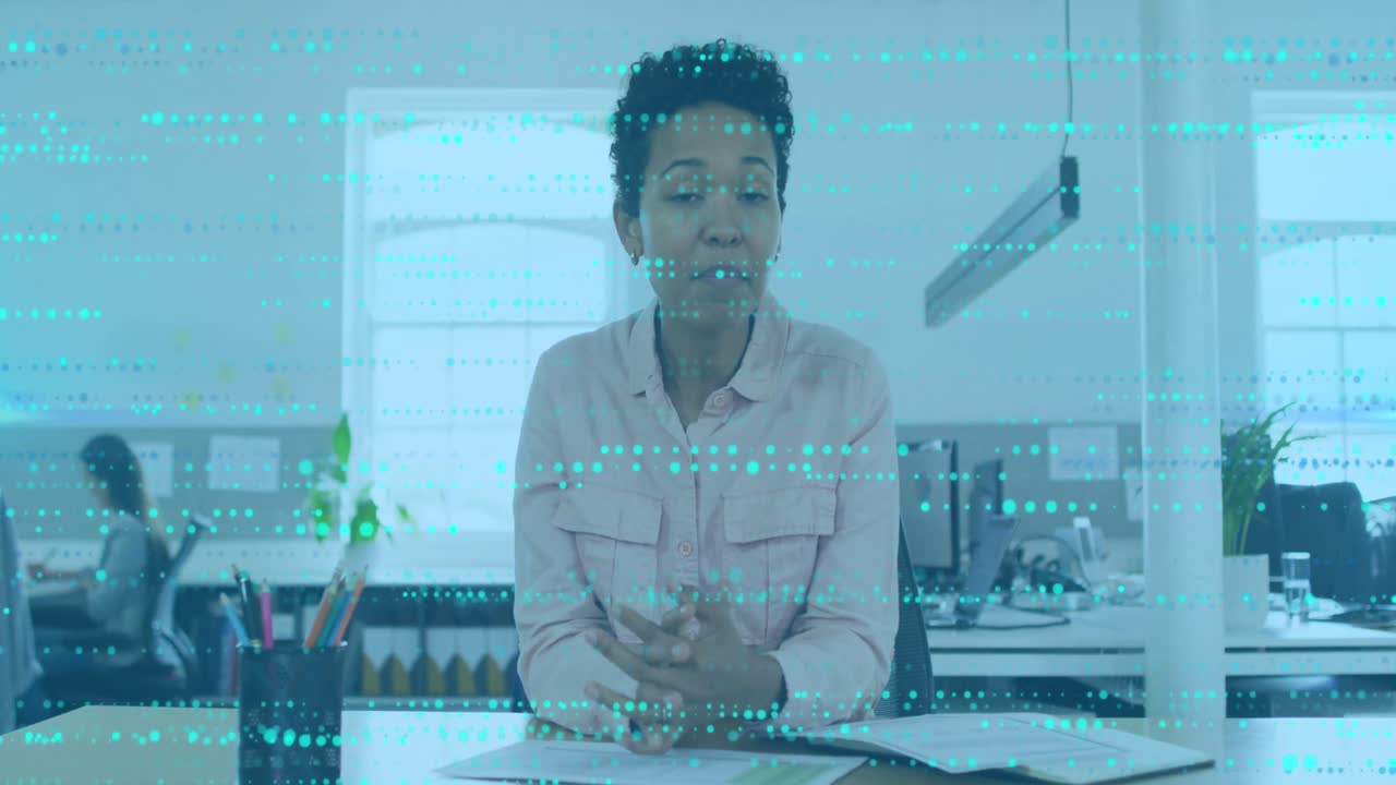 Animation of data processing over african american businesswoman talking in office