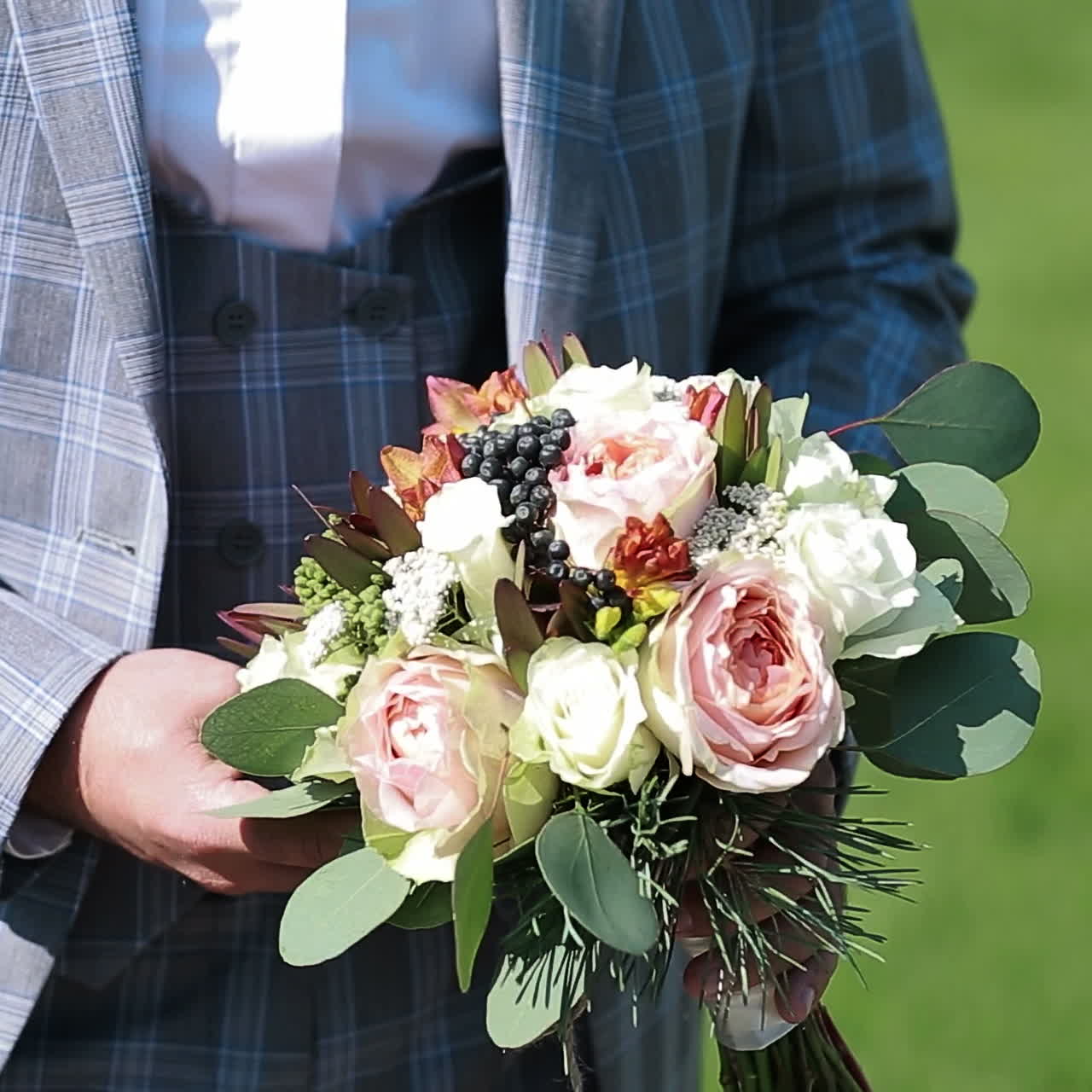 Damat düğün buketi tutuyor. Çiçekli genç adam. Kare video.