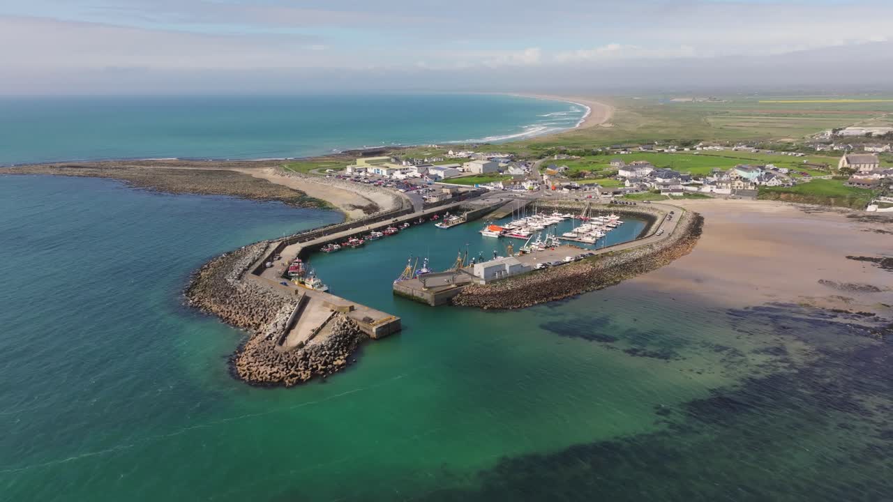 4K cinematic drone footage capturing Kilmore Quay, on a bright day, showcasing the picturesque harbour, and colourful fishing boats Co.Wexford - Ireland_003