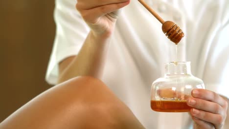 -Woman-getting-her-legs-waxed-by-beauty-therapist