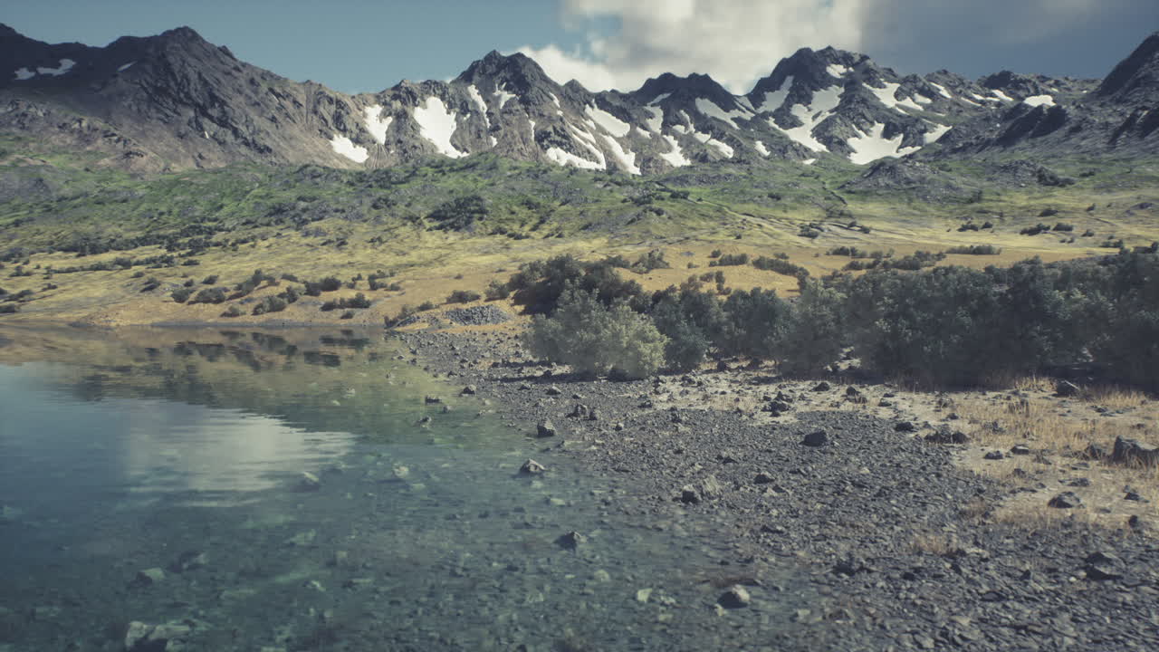 Tranquil lakeside view with mountains in the background on a clear day