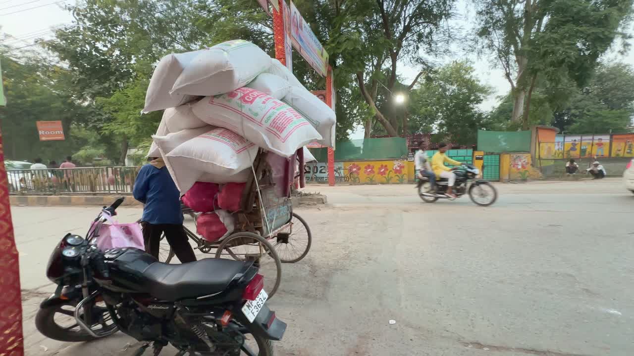 Hardworking Indian Cycle rickshaw driver delivering heavy goods