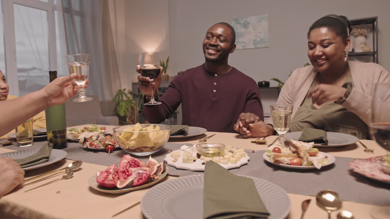 African American Family Toasting at Dinner Table