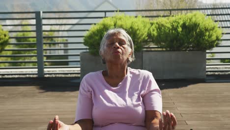 Video-of-relaxing-senior-african-american-women-meditating-in-the-garden