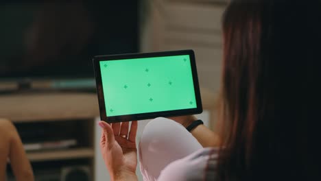 mother watching video on tablet near child