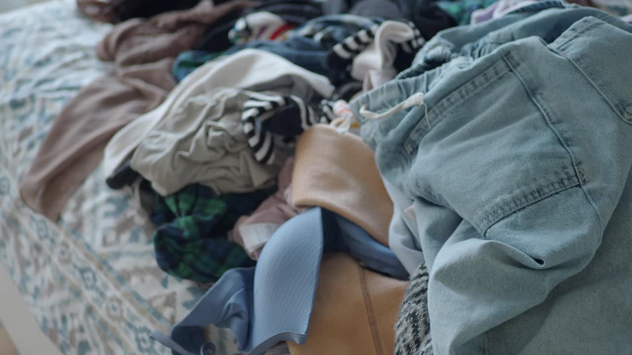 A pile of clothes with jeans on top