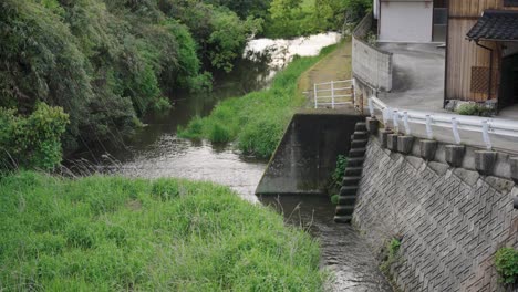 rural japanese town with river and weir, daisen town, tottori japan