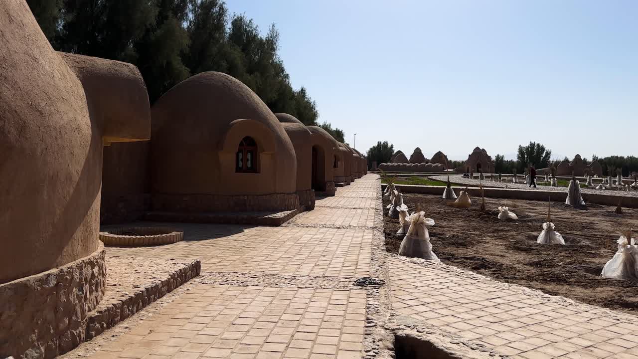 Desert traditional house ancient architecture in Iran mudbrick village serene landscape middle east rural oasis scenic travel heritage tranquil nature picturesque rocky settlement sustainable tourism