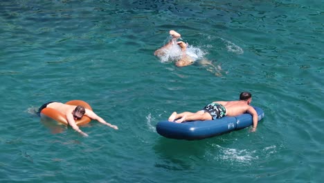 two people swimming and floating in the sea