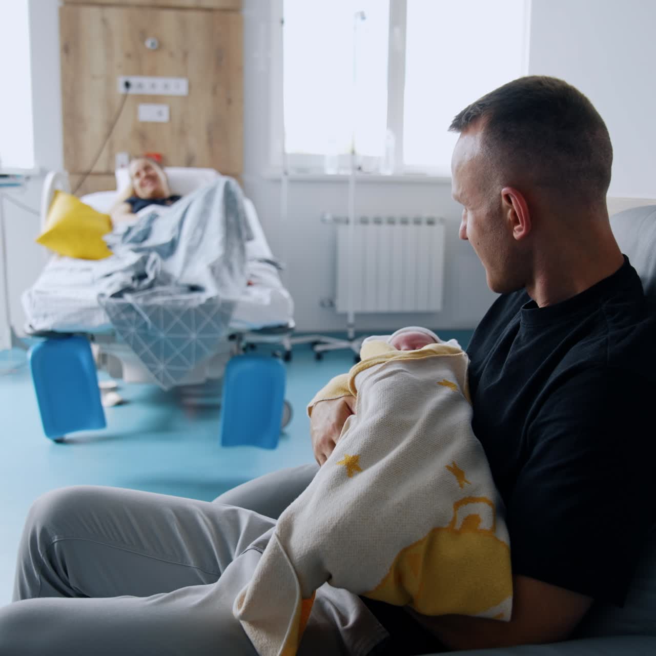 Infant small child parenthood concept. Newborn baby holding on young father hands