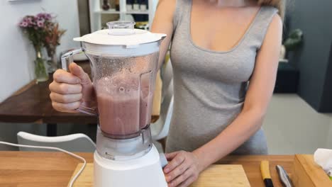 woman preparing a smoothie