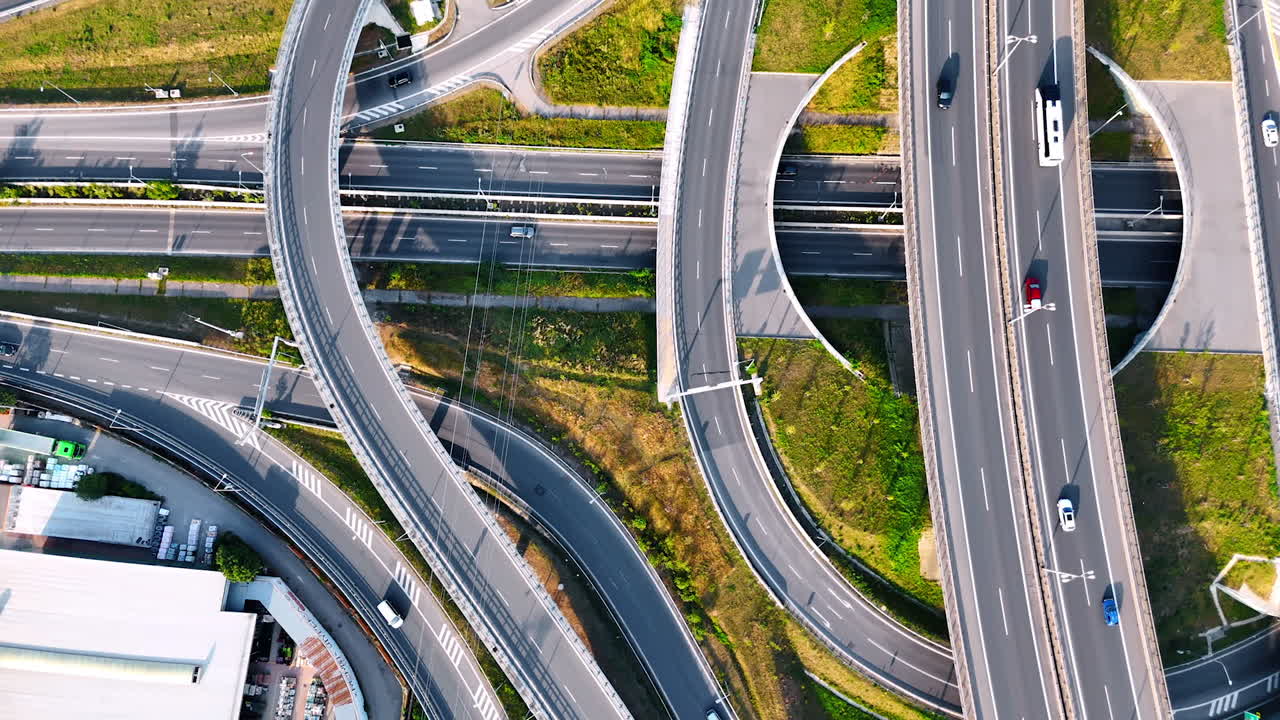 Road conjunction from top view. Cars run by the loops, highways and freeways. Sunny day footage.