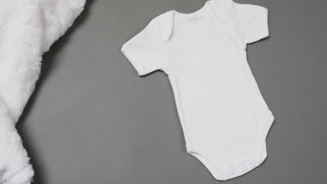 video of white baby grow with copy space on grey background